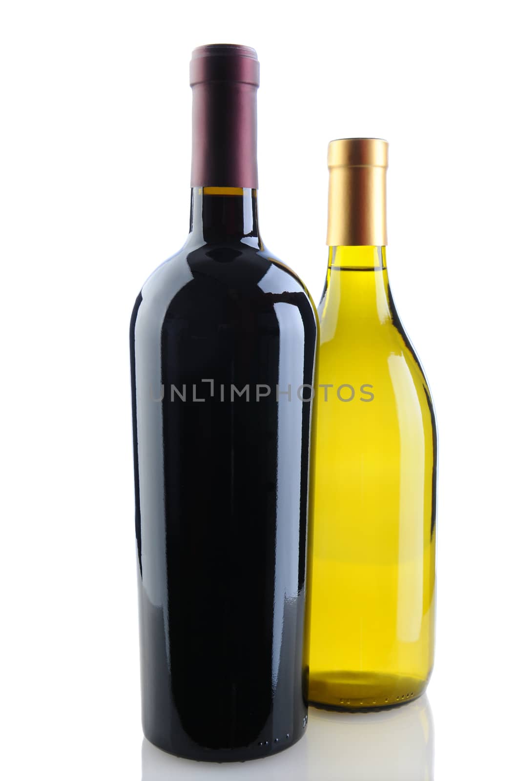 Close up of a cabernet sauvignon and chardonnay wine bottles on a white background with reflection. Chardonnay bottle is tucked behind the Cabernet bottle. Vertical Format.