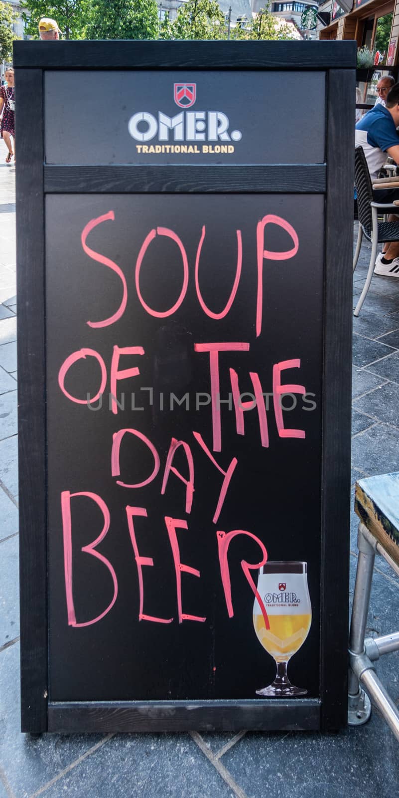 Antwerpen, Belgium - June 23, 2019: Pink on blackboard sign reading Soup of the Day, Beer, with advertisement for Omer ale.