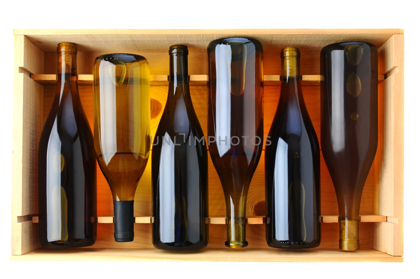 Six bottles of Chardonnay wine in a wooden case, view from above over a white background.