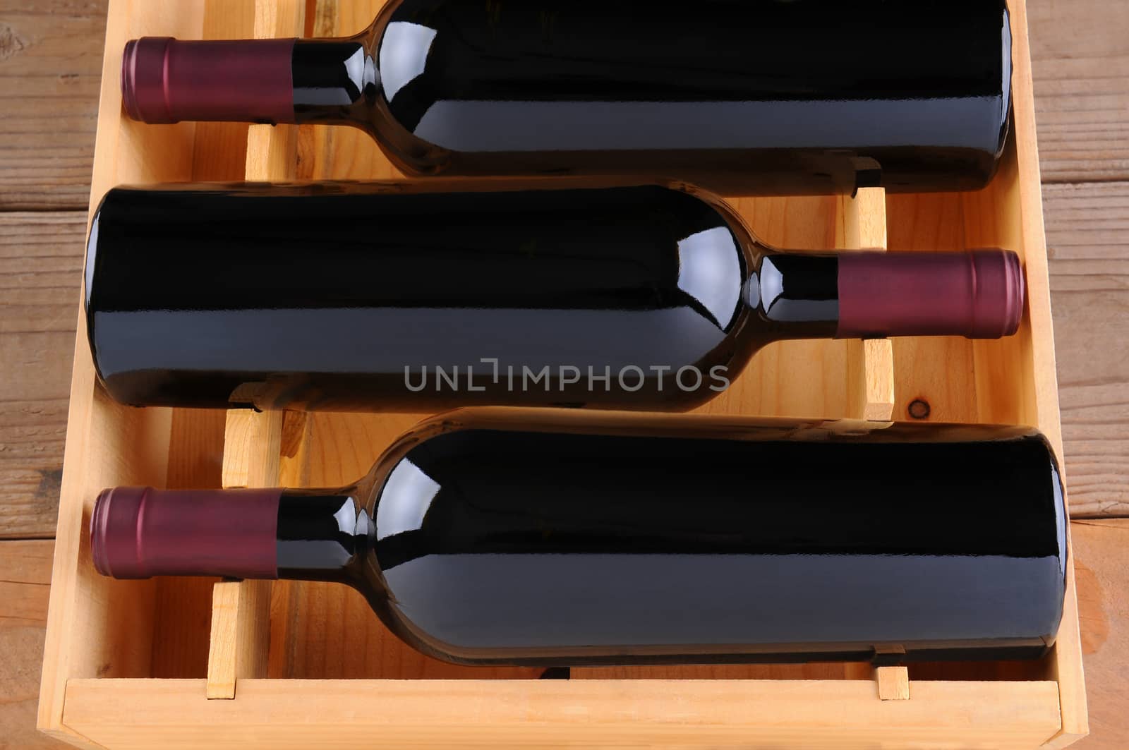 Three Red Wine Bottles in Wood Case by sCukrov