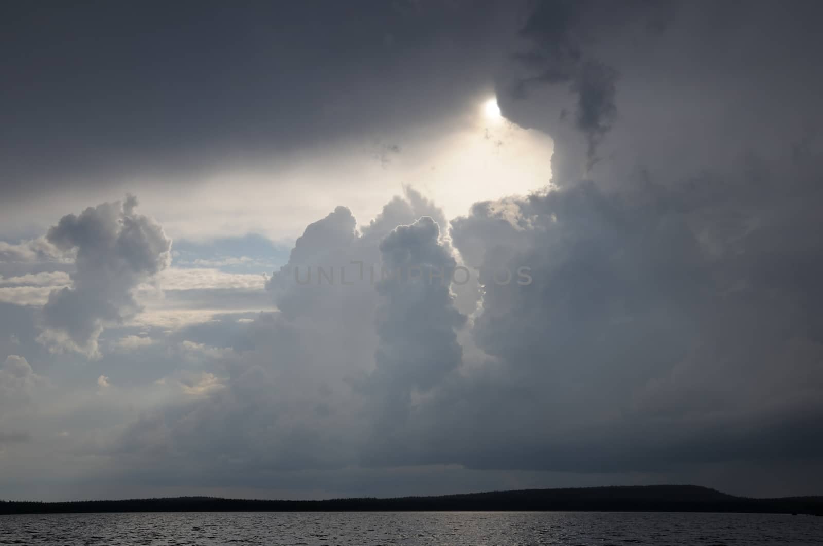 The picture shows rainstrom and thunderstorm clouds over lake