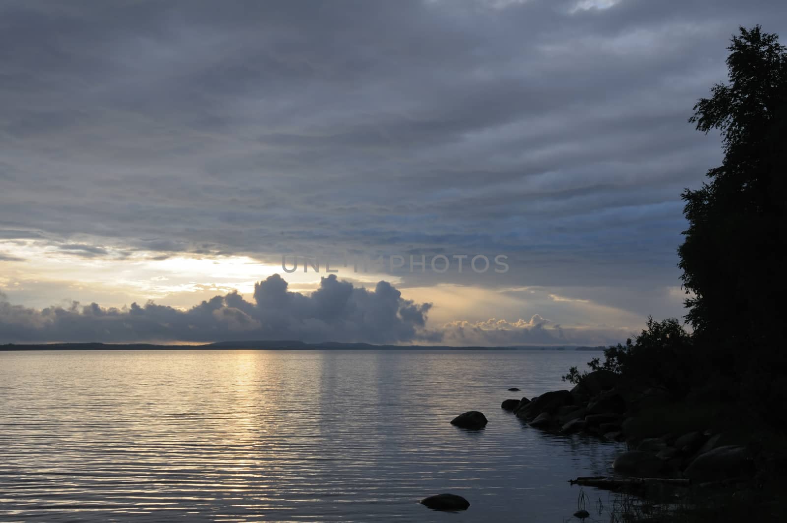 Distant rainstorm clouds over lake by nemo269