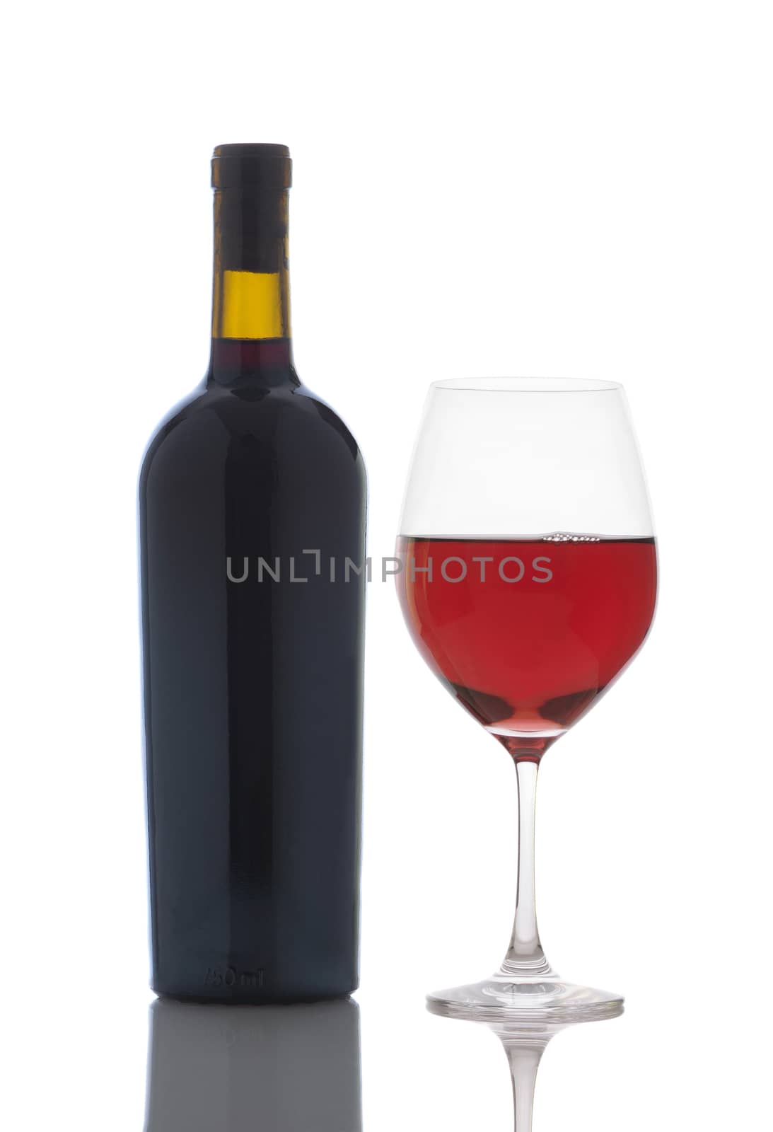 Glass of Red Wine and Bottle isolated on white. Vertical format with reflection.