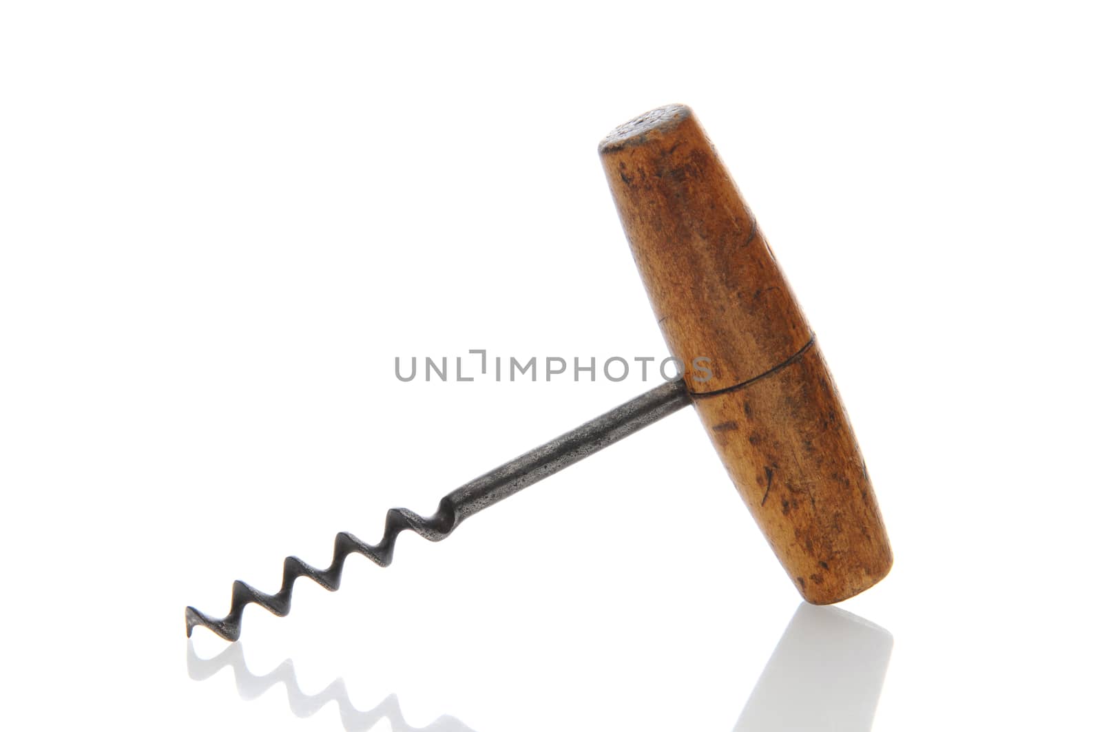 Closeup of an antique wooden handled corkscrew over a white background with reflection.