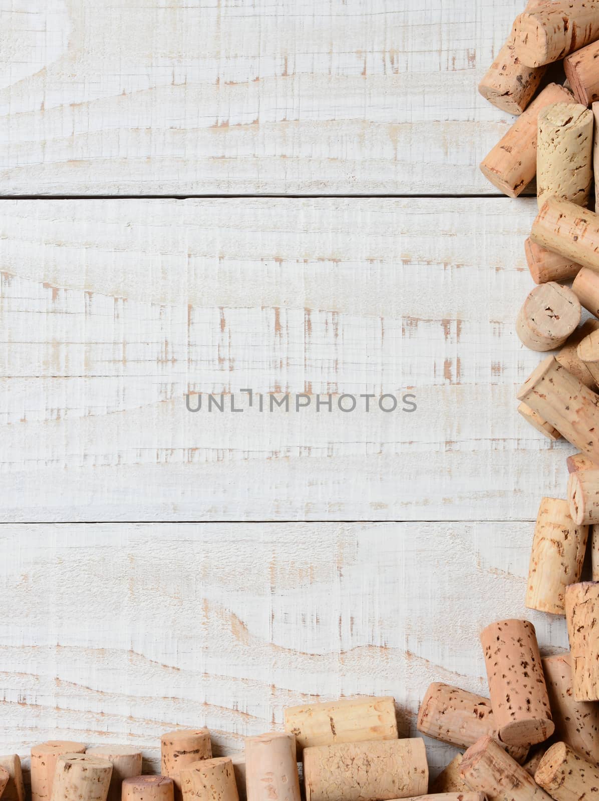 A partial cork frame on two sides of the image. High angle shot on a rustic whitewashed wood table, Suitable for wine lists with lots of copy space.