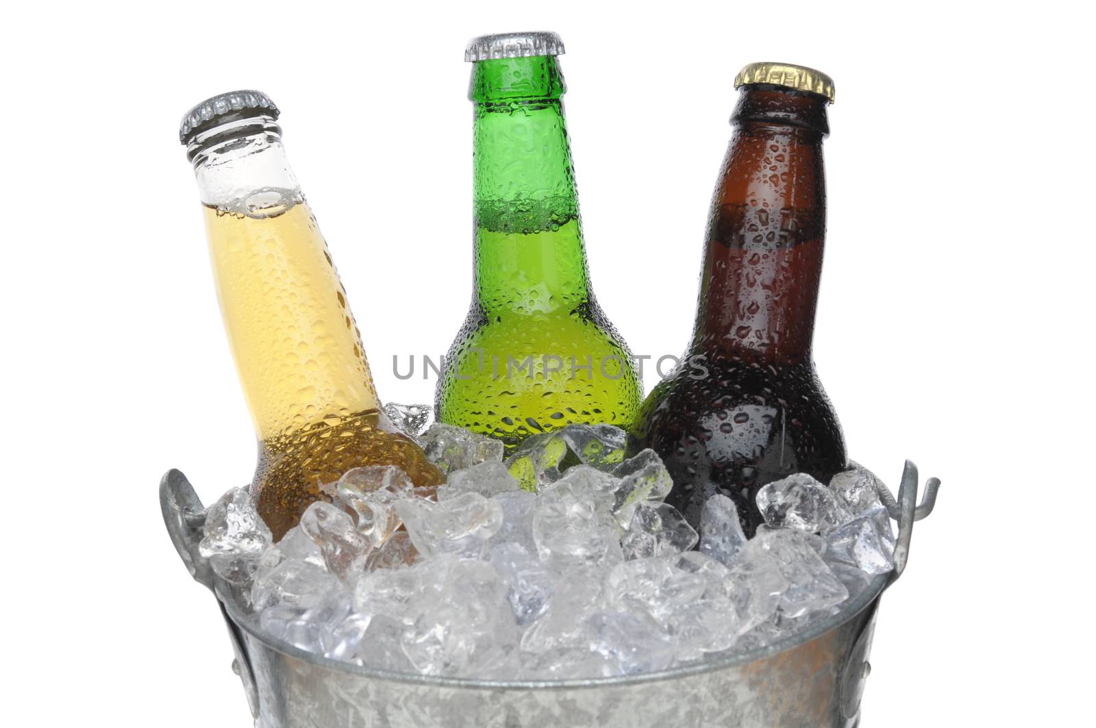 Close up of Three Different Beer Bottles in bucket of ice with condensation horizontal composition over white background