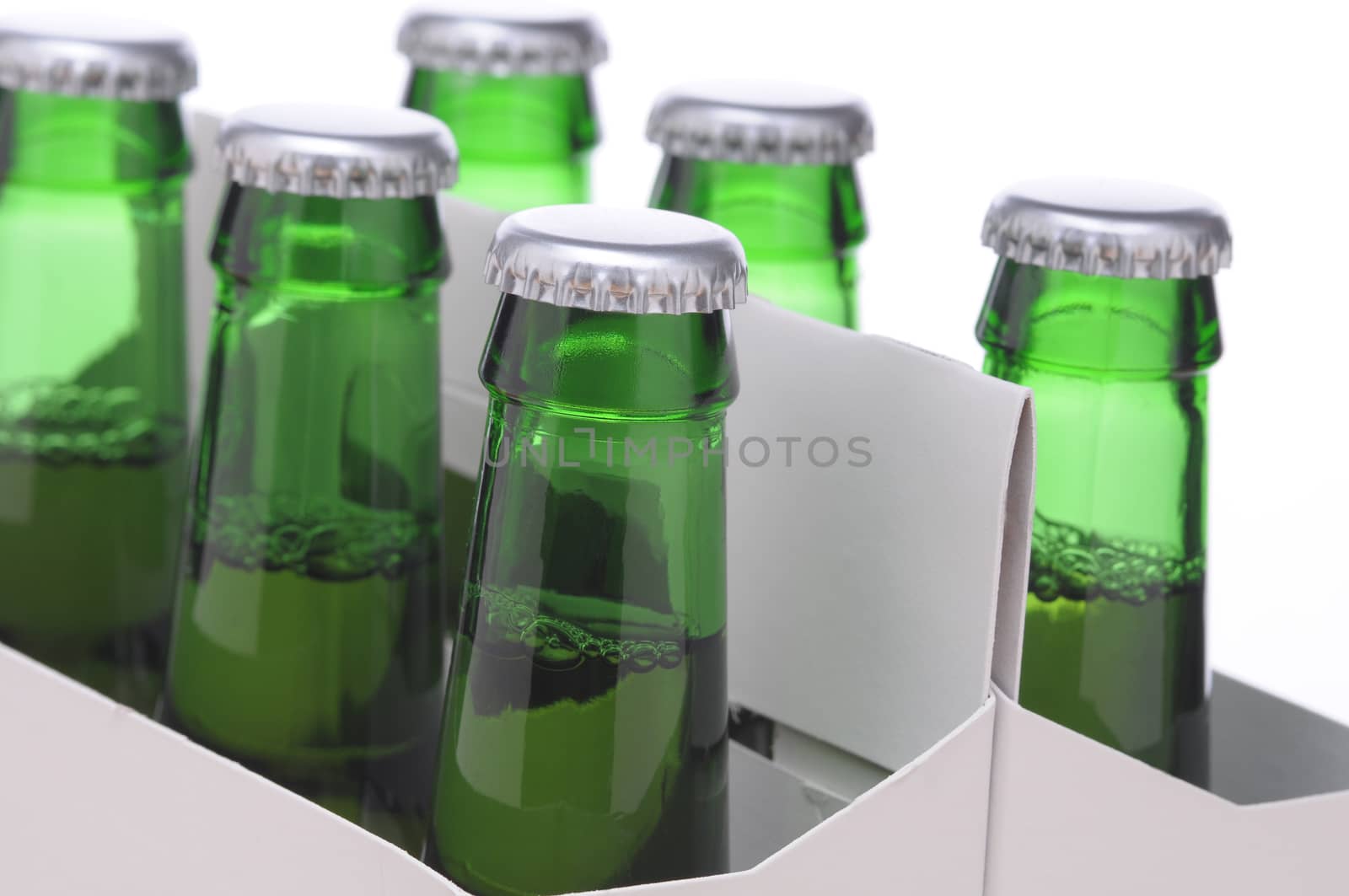 Close up of a Six Pack of Green Beer Bottles in Cardboard Carrier isolated on horizontal format