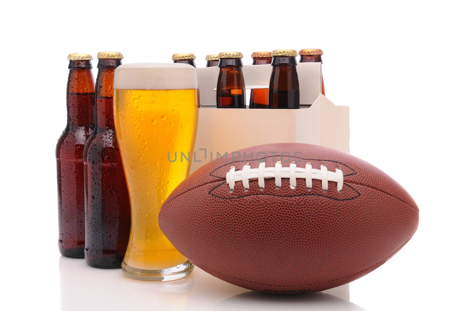 Six pack of beer and frothy glass with an American Football in front. Horizontal format isolated on white with reflection.