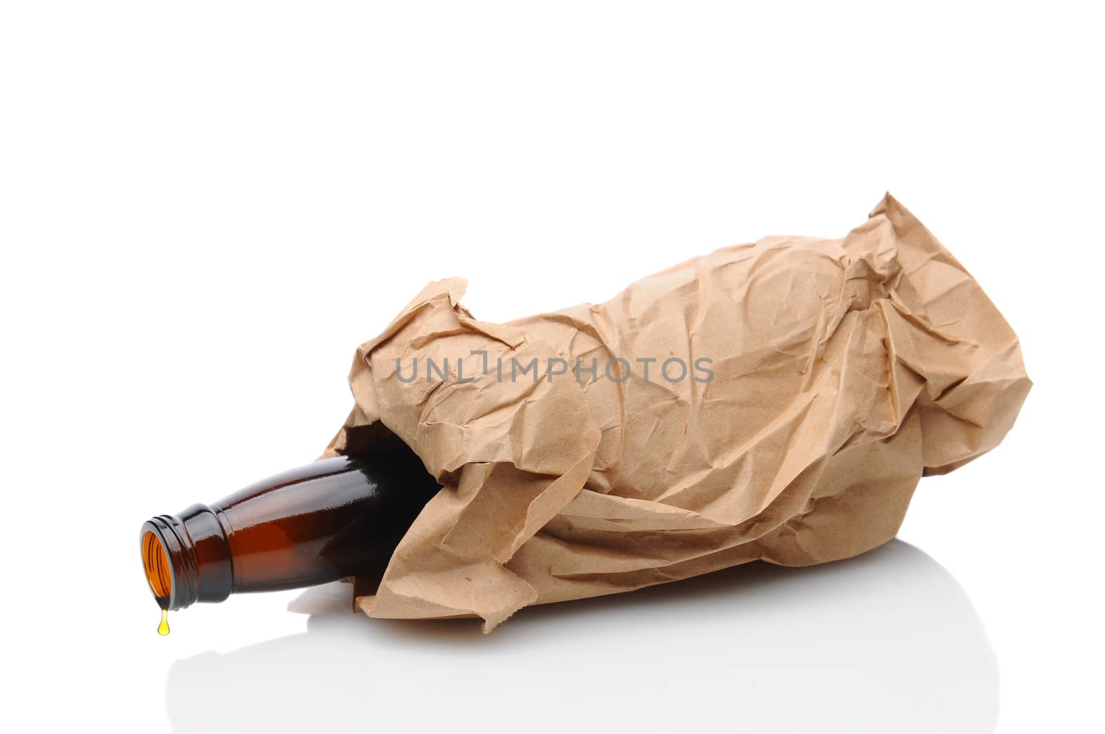 Closeup of a beer bottle inside a brown paper bag laying on its side with a drip on the lip of the container. Isolated on white with reflection.