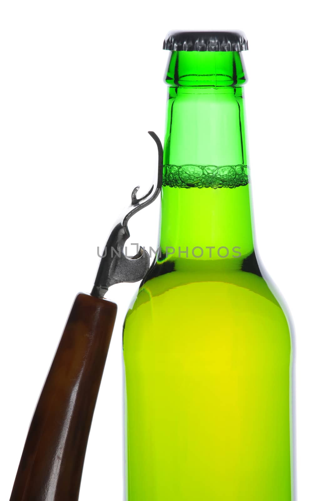 Green beer bottle with opener leaning against the side of the bottle, vertical composition isolated on white background.