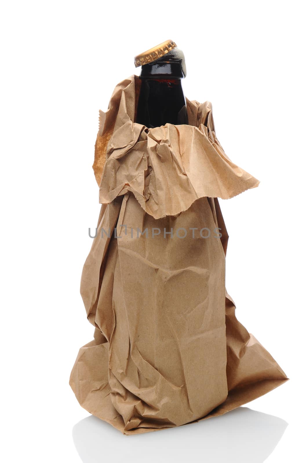 Closeup of a beer bottle inside a brown paper bag. Cap is partially off with foam popping out of the bottle neck.
Isolated on white with reflection.