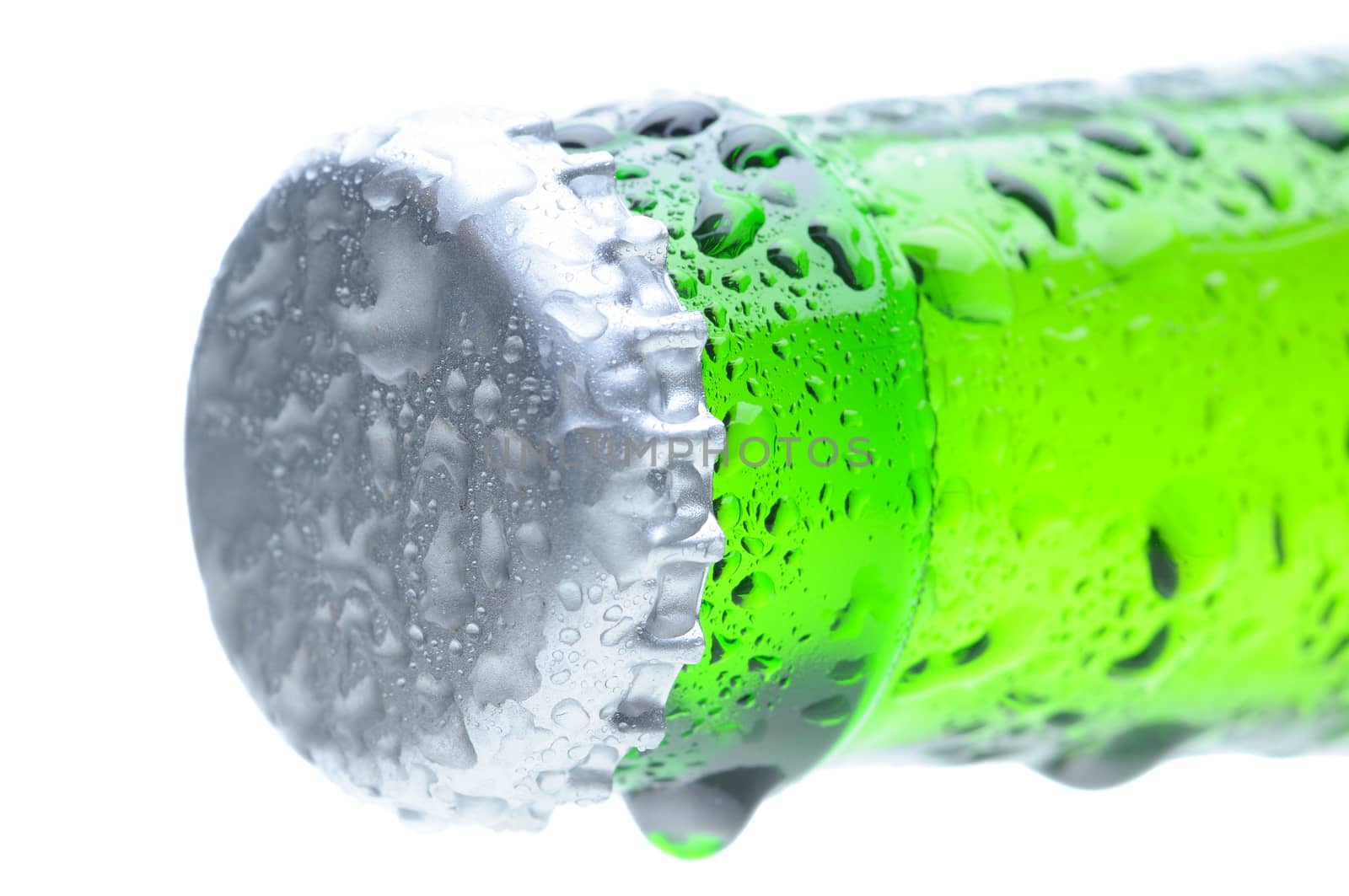 Closeup of a brown beer bottle cap and neck covered with condensation. Horizontal format over a white background. Bottle is at an angle focus on the bottle cap. Shallow Depth of Field.