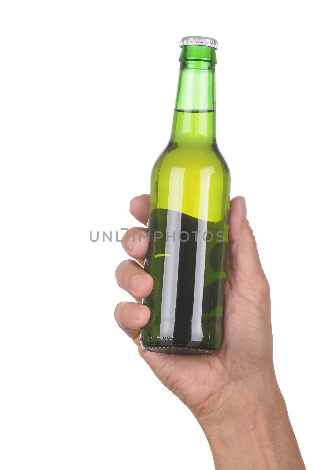 Man's hand holding up a green beer bottle without label over a white background vertical format