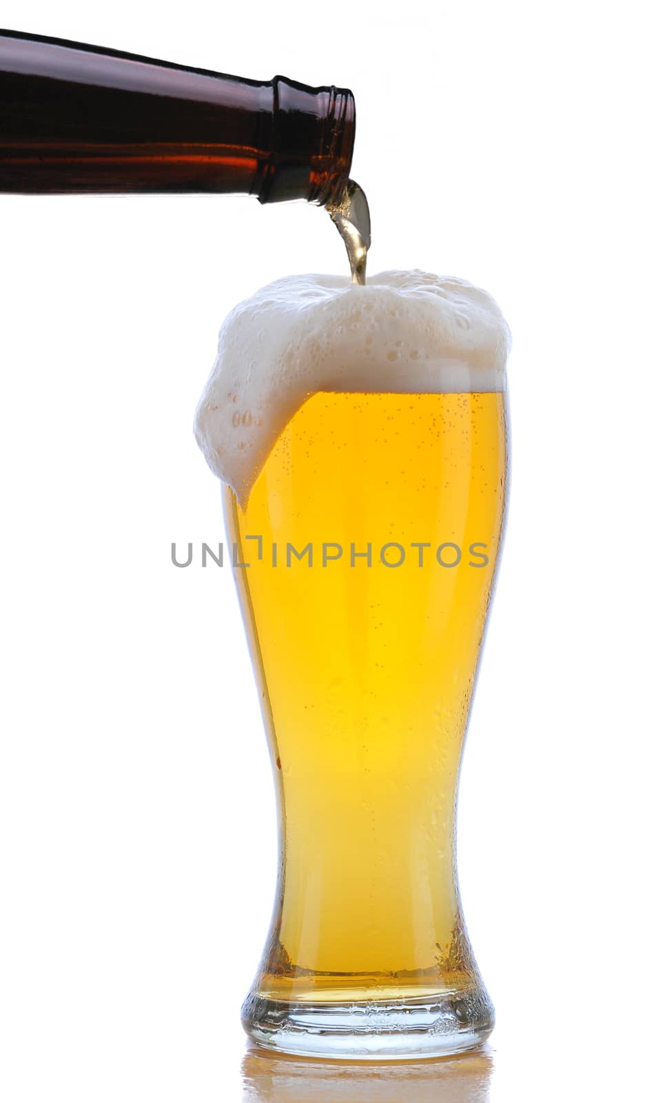 Glass of Beer being Poured from Bottle with Foam Drip and Reflection isolated on white