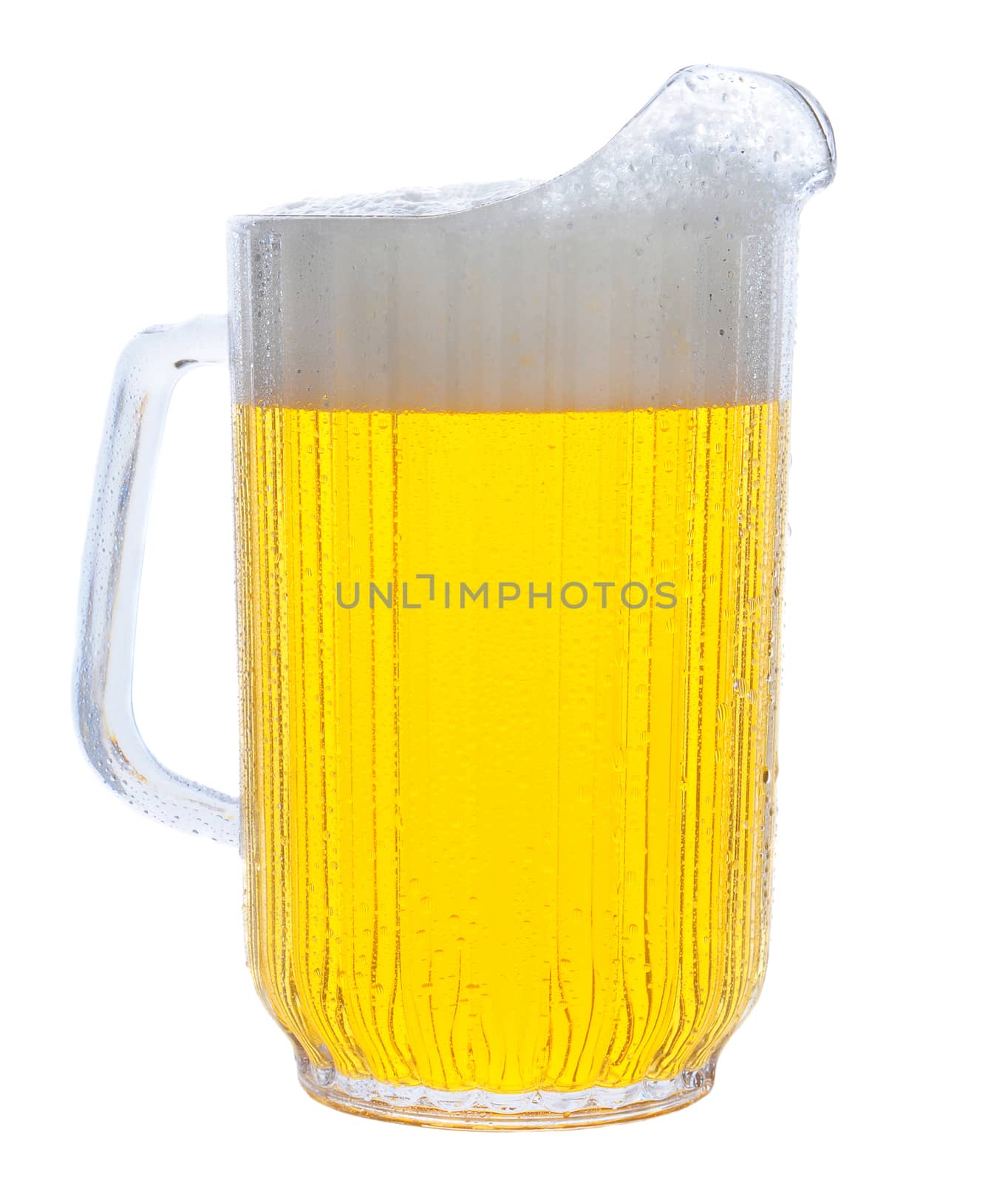 Pitcher of beer in vertical format over white.