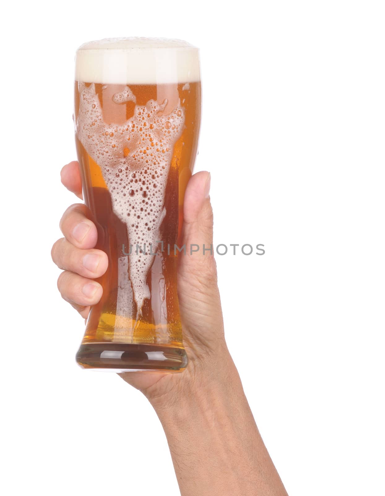 Man's Hand Holding up a Glass of Foamy Beer with froth dripping down the side over a white background