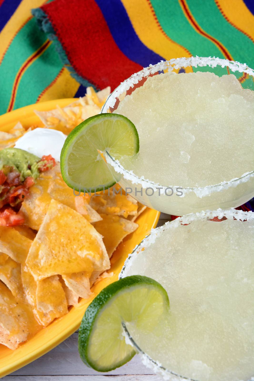 Cinco de Mayo Concept: Margaritas and Mexican food on a colorful  table cloth.