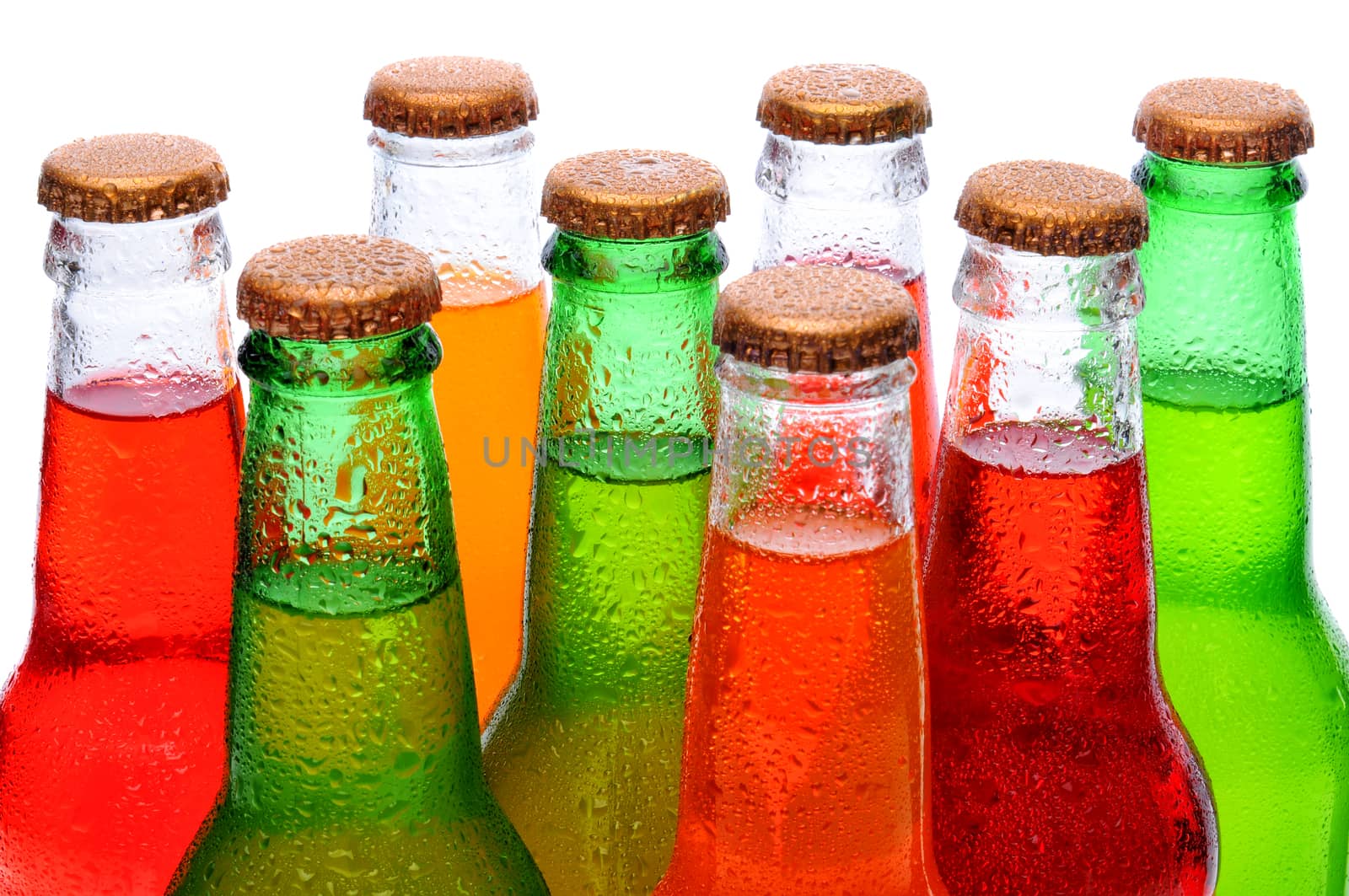 Closeup of several assorted flavors of soda pop. Orange, lemon lime, and strawberry soda bottles necks only over a white background.