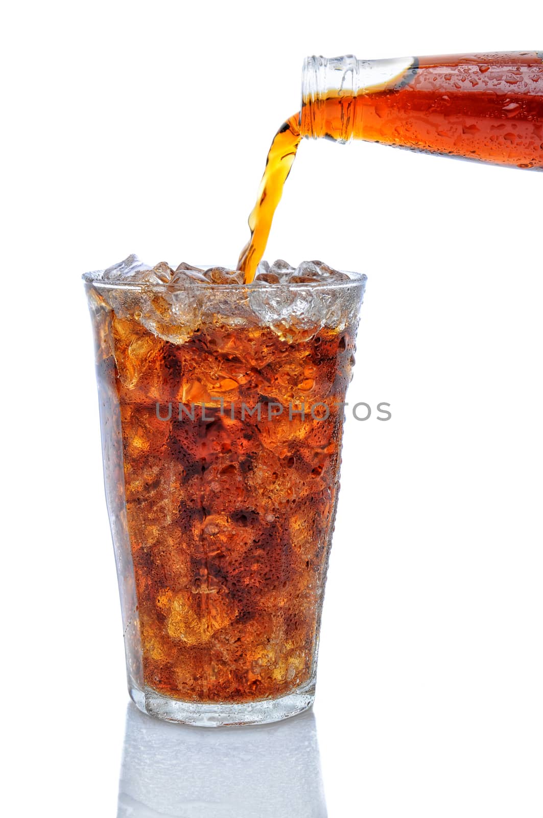 Cola Pouring from Bottle into Glass of Ice by sCukrov