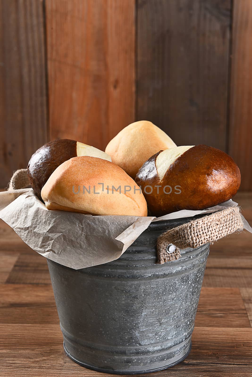 Closeup of a bucket filled with dinner rolls. Vertical format with copy space.