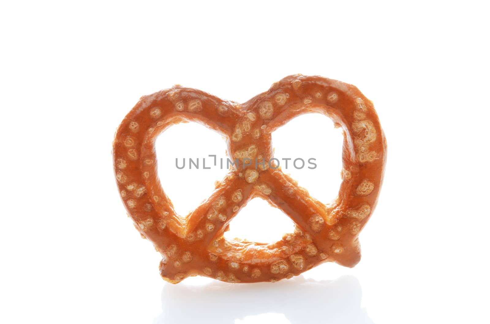 Closeup of a sour dough pretzel over a white background with reflection.