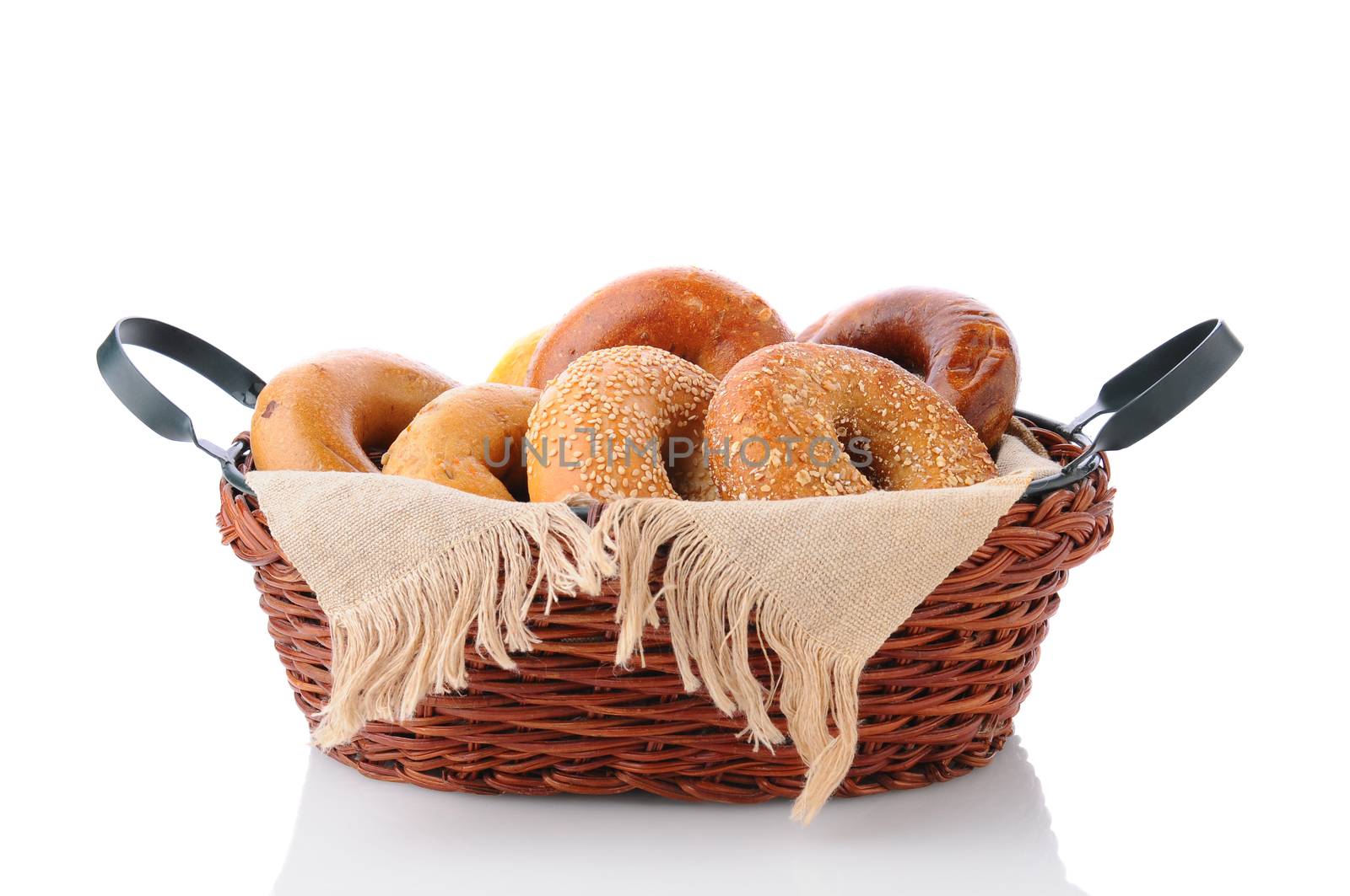 A basket of fresh baked bagels. Horizontal format isolated on white with reflection.