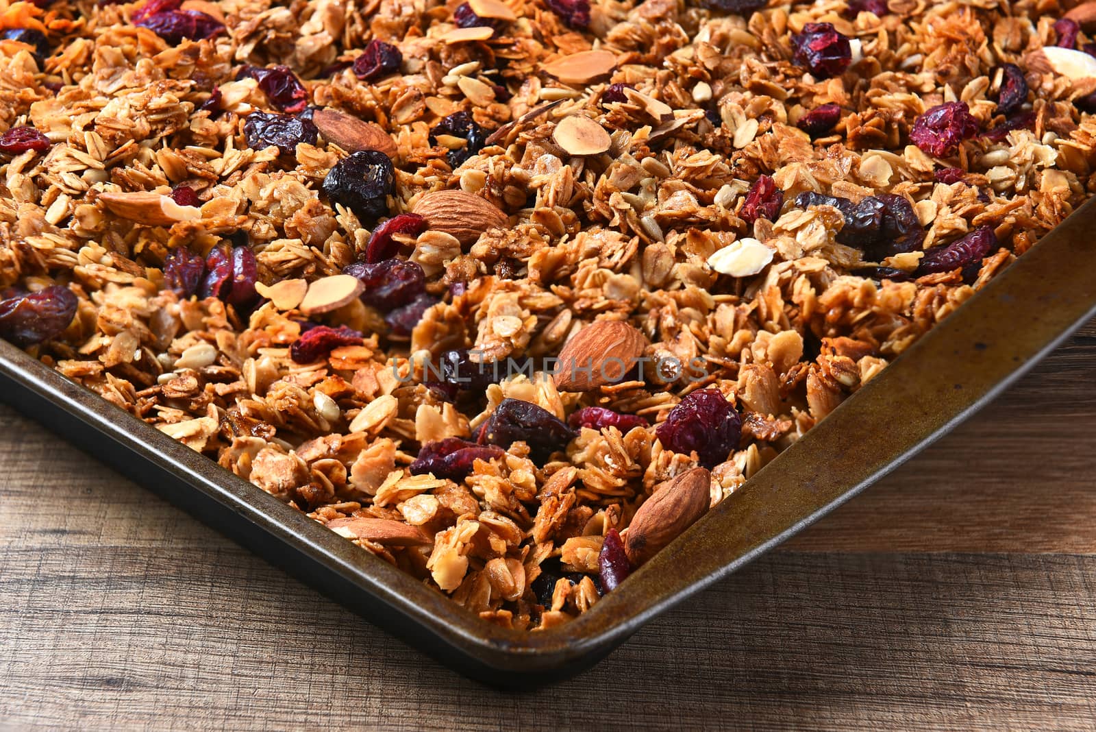 Closeup of a baking sheet full of homemade granola.
