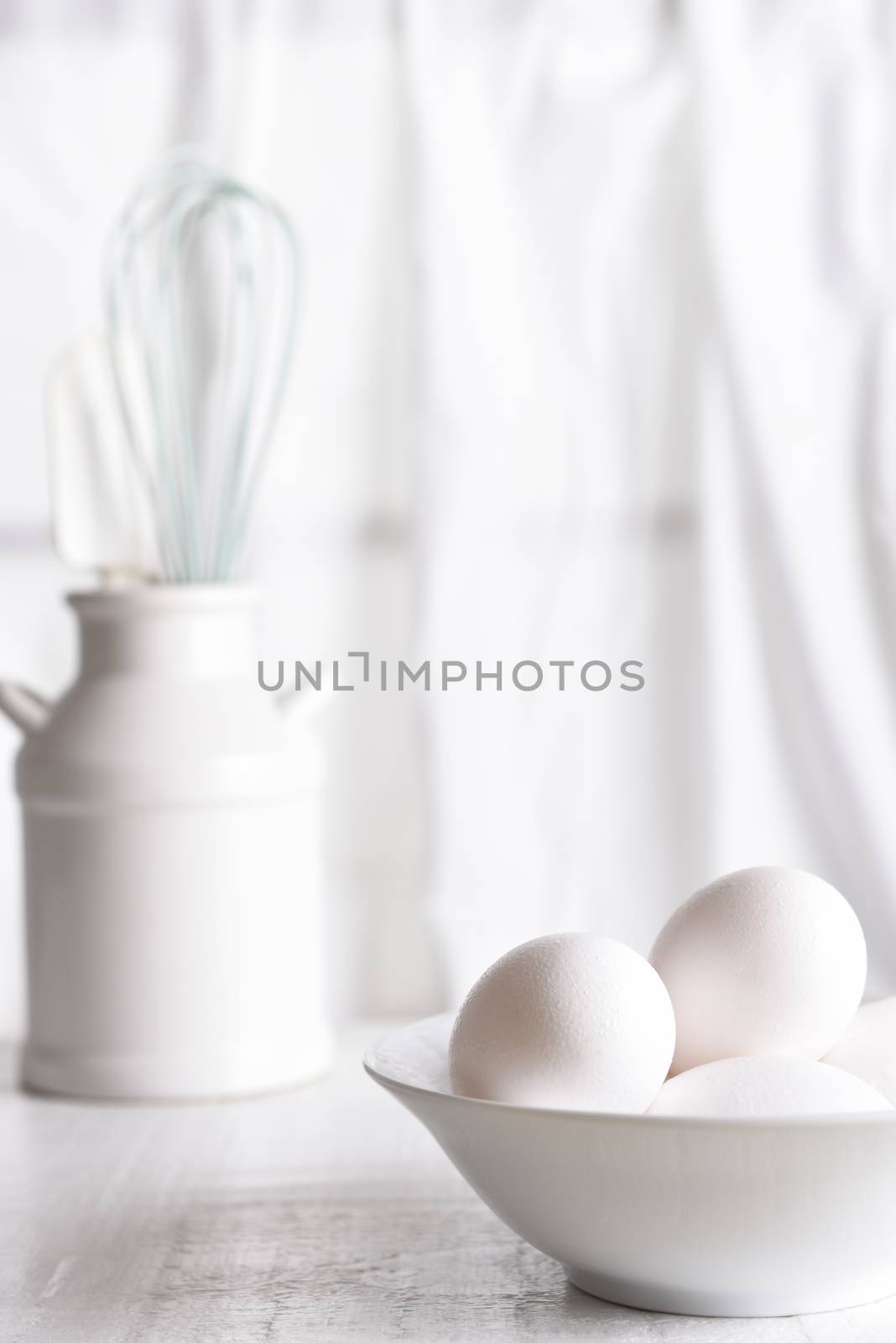 Fresh eggs in a white bowl in front of a window  by sCukrov