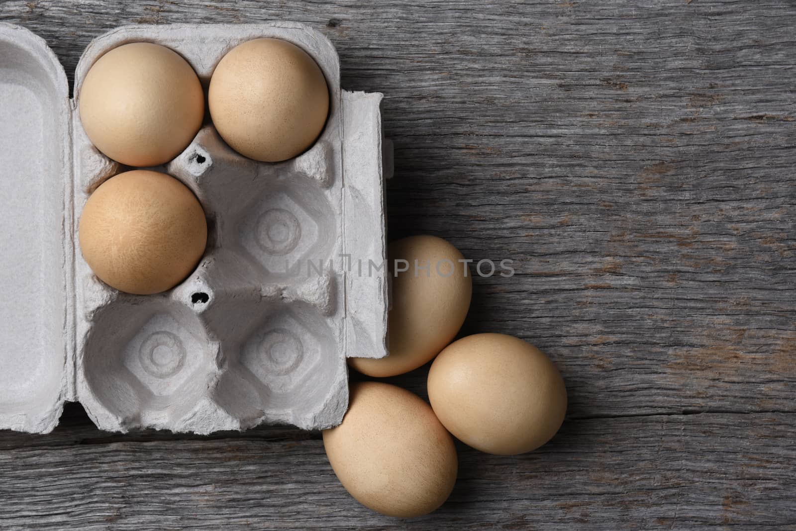 A carton of fresh eggs three eggs in the carton by sCukrov