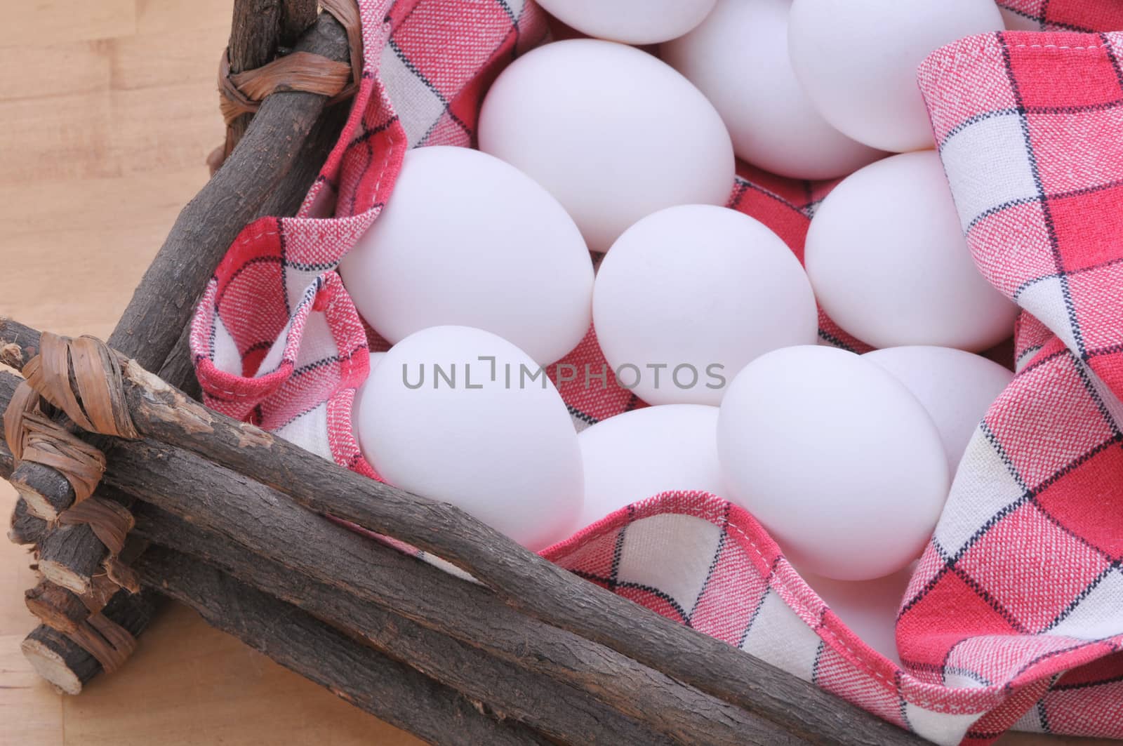 Eggs in a rustic basket with checkered napkin