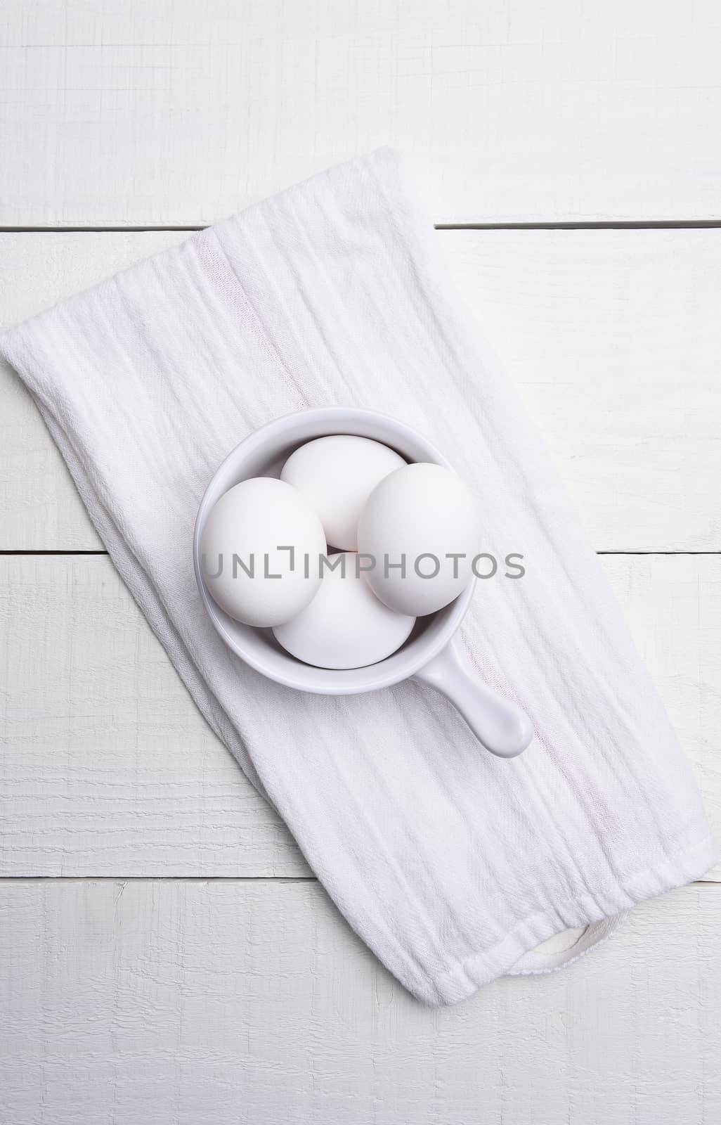 Eggs in Bowl on Kitchen Towel by sCukrov