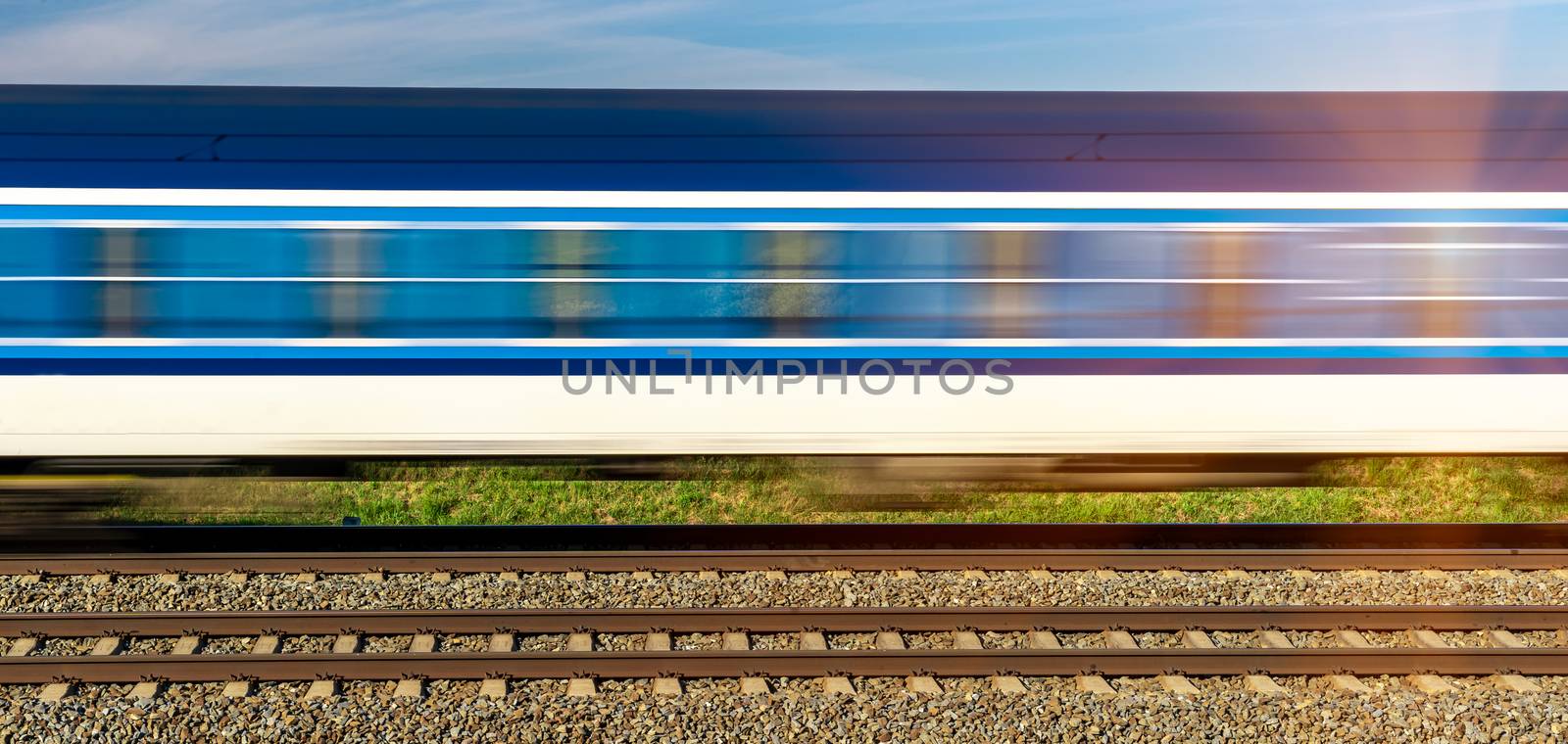 wagons of an express train passing along the tracks by Edophoto