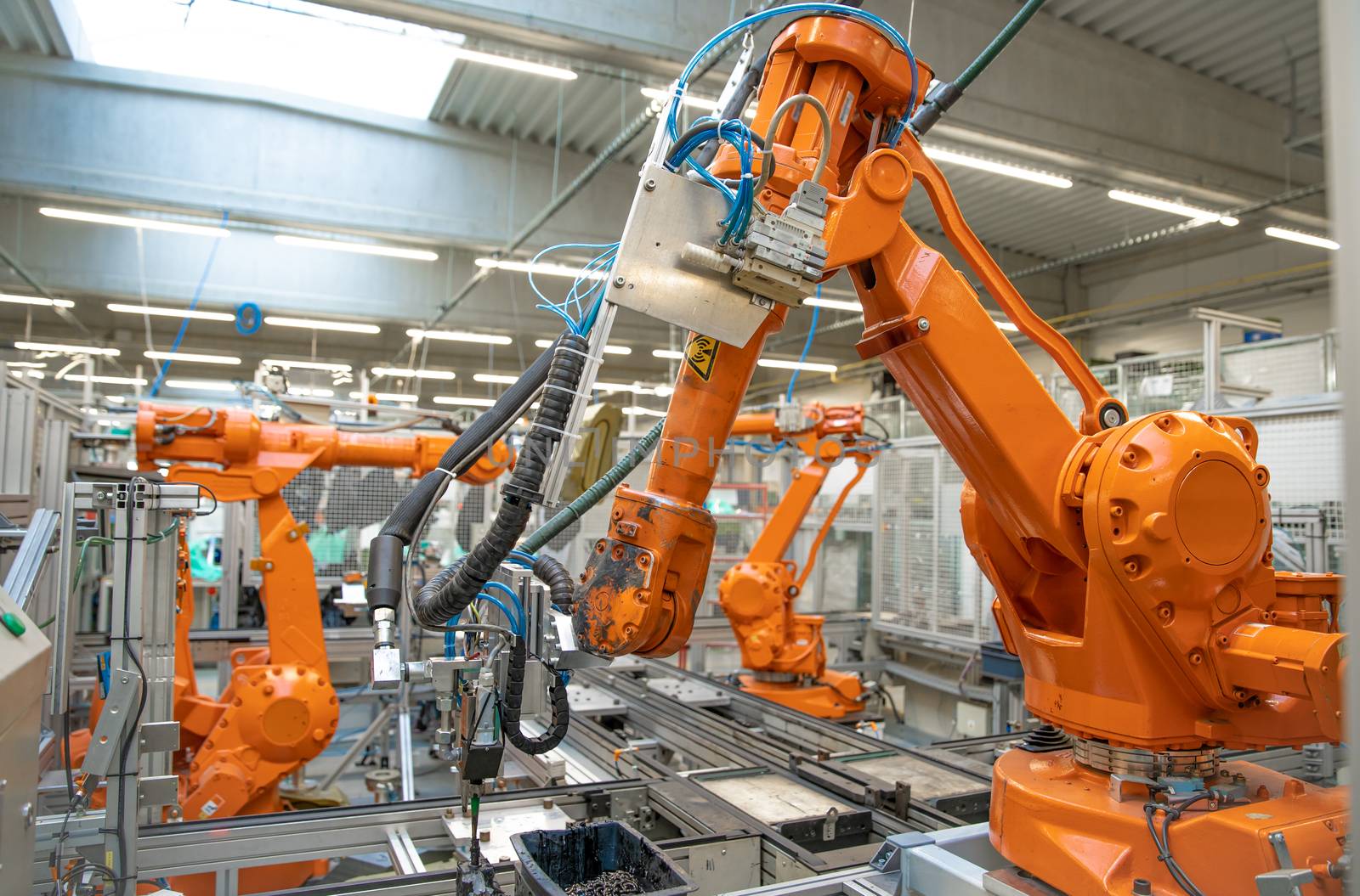 orange robot arms on the production line. controlled by a computer with artificial intelligence.