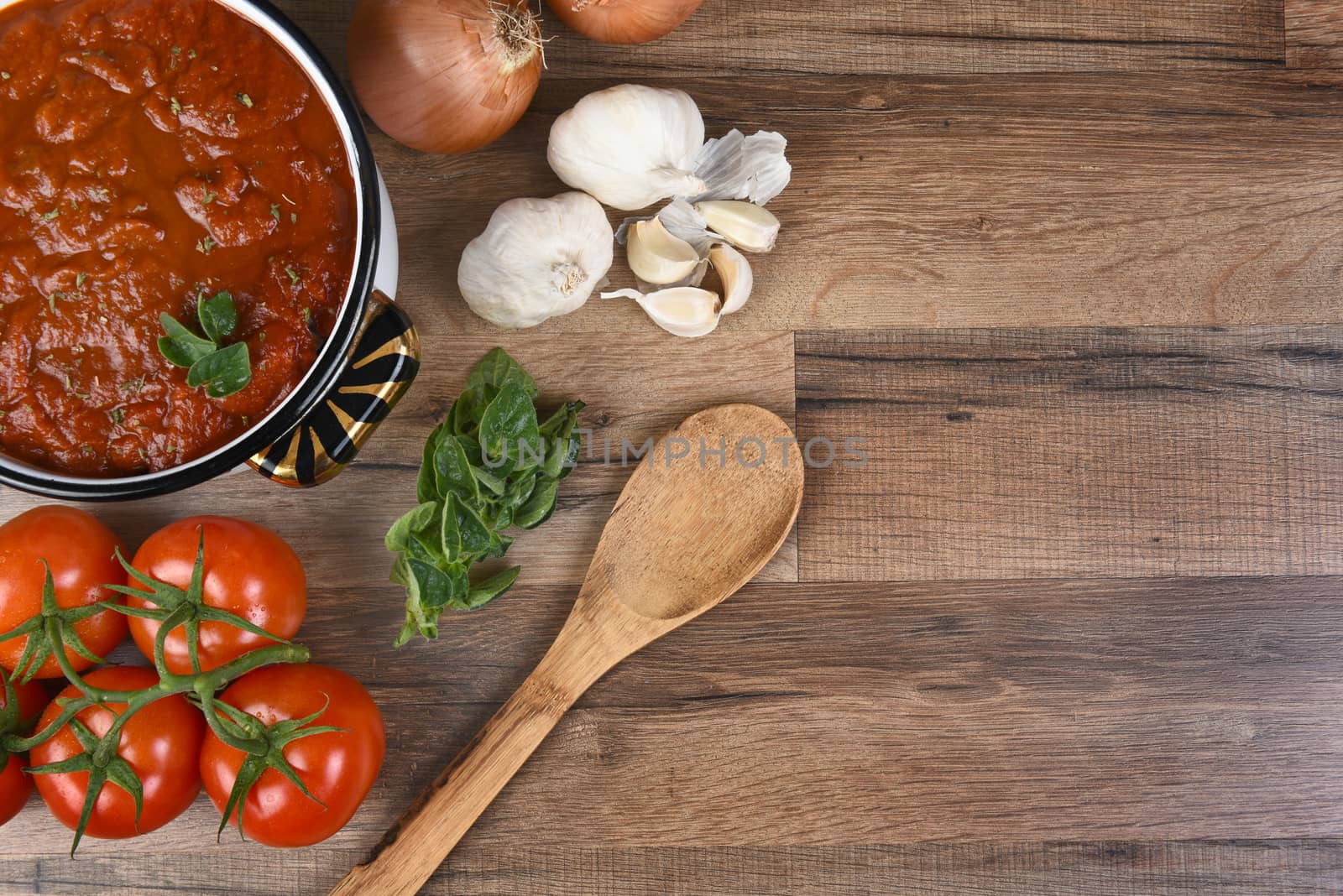 Top view of ingredients for making tomato sauce. Horizontal format with copy space.