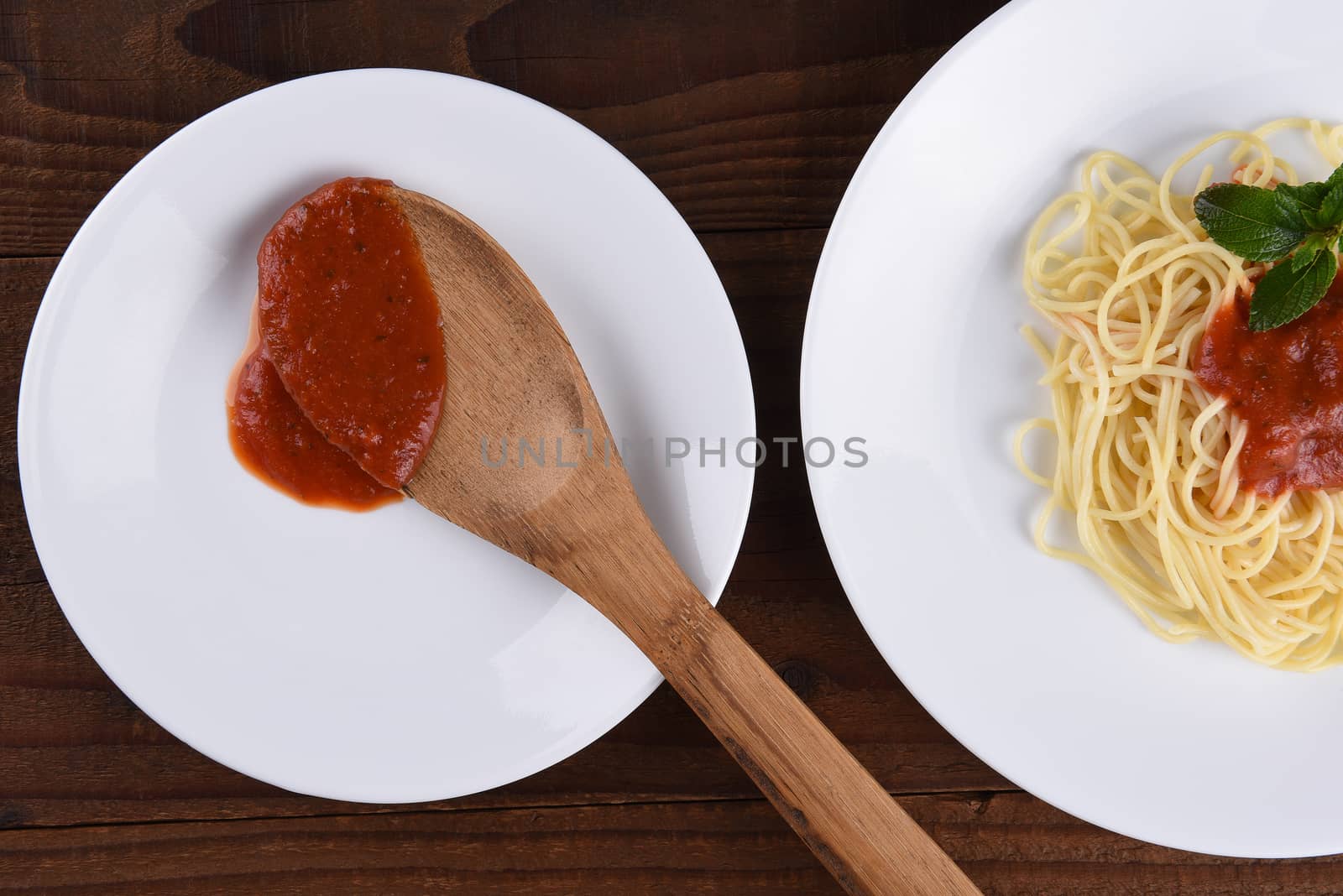 Spaghetti and Sauce on White Plates by sCukrov