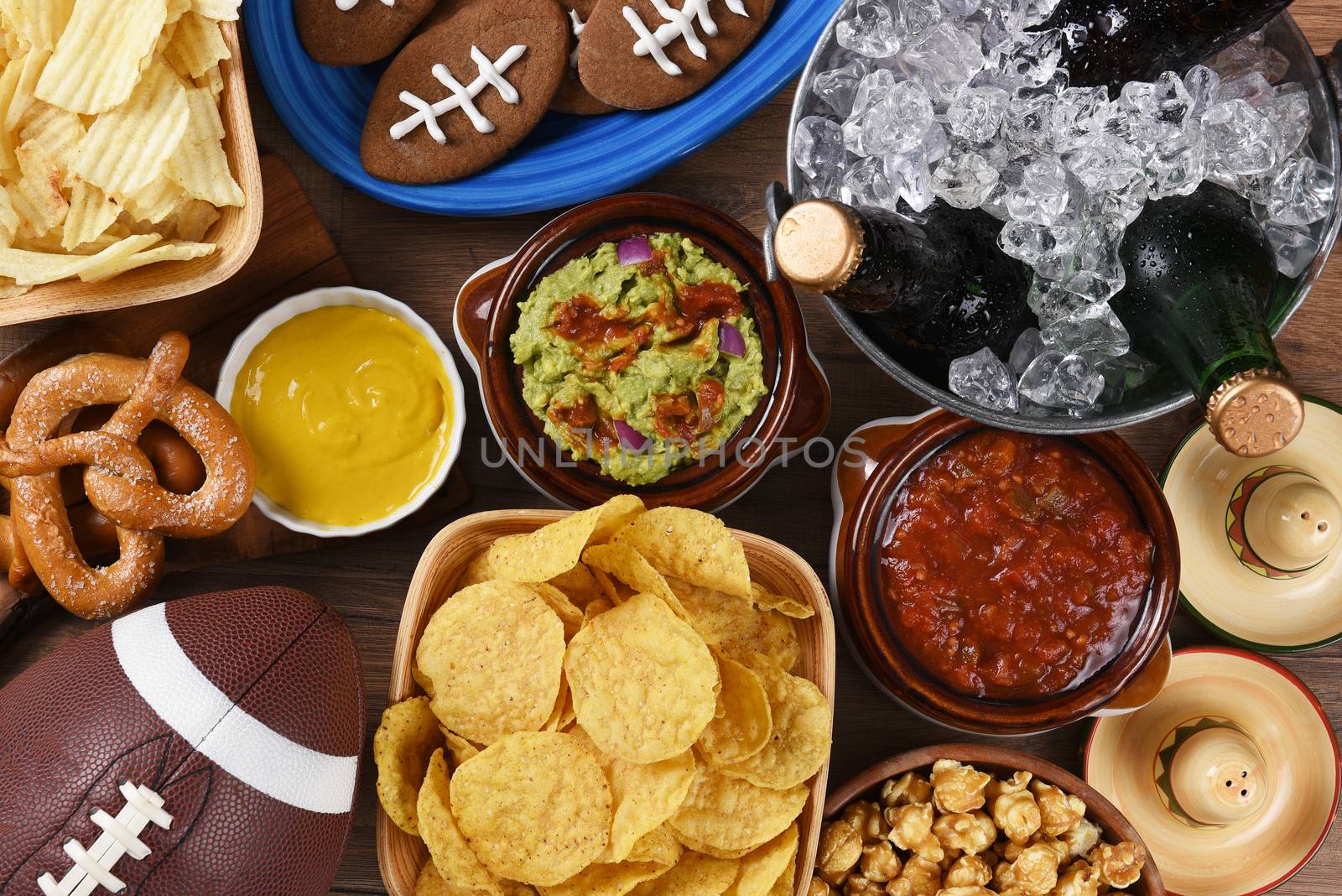 Top view of snacks and drinks laid out for a football watching party. 