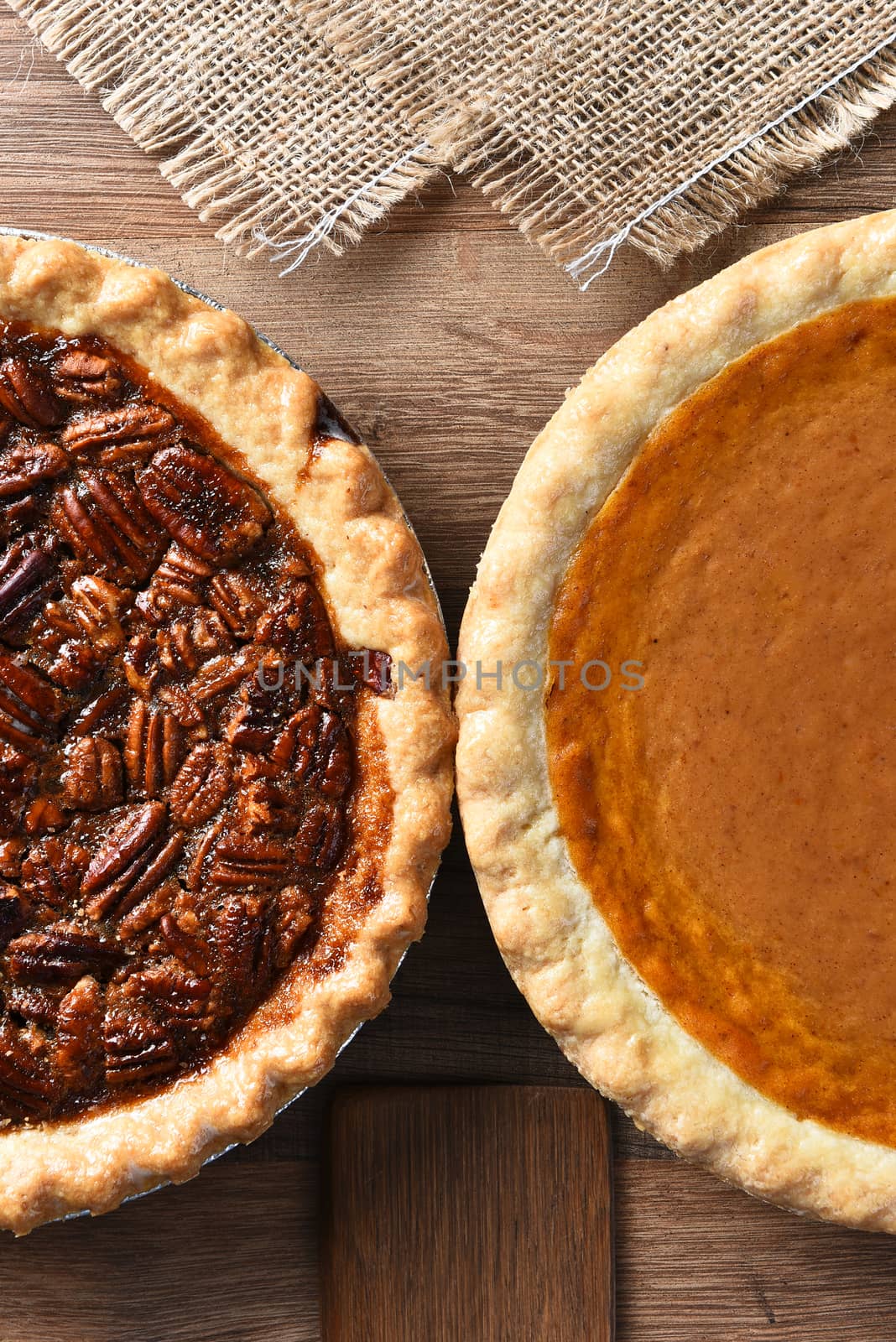 Two pies on a Thanksgiving holiday table. Pumpkin and pecan pies are traditional desserts for the American holiday.