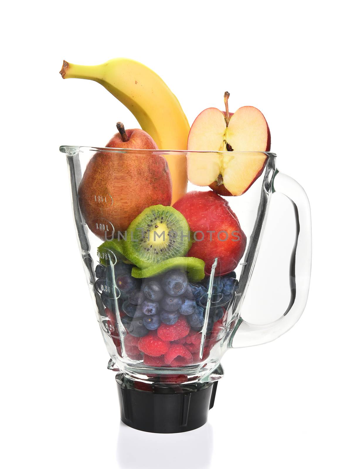 A blender filled with fresh whole fruits for making a smoothie or juice. Healthy eating concept. 