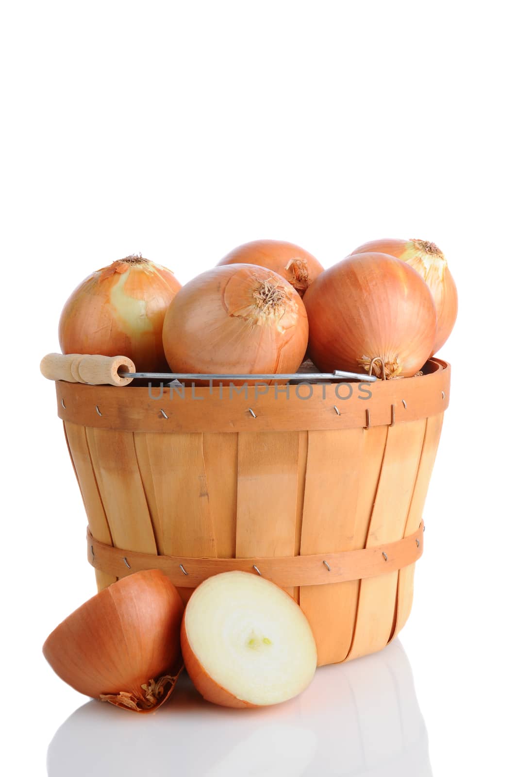 Closeup of brown onions in a bushel basket, isolated on white with reflection.