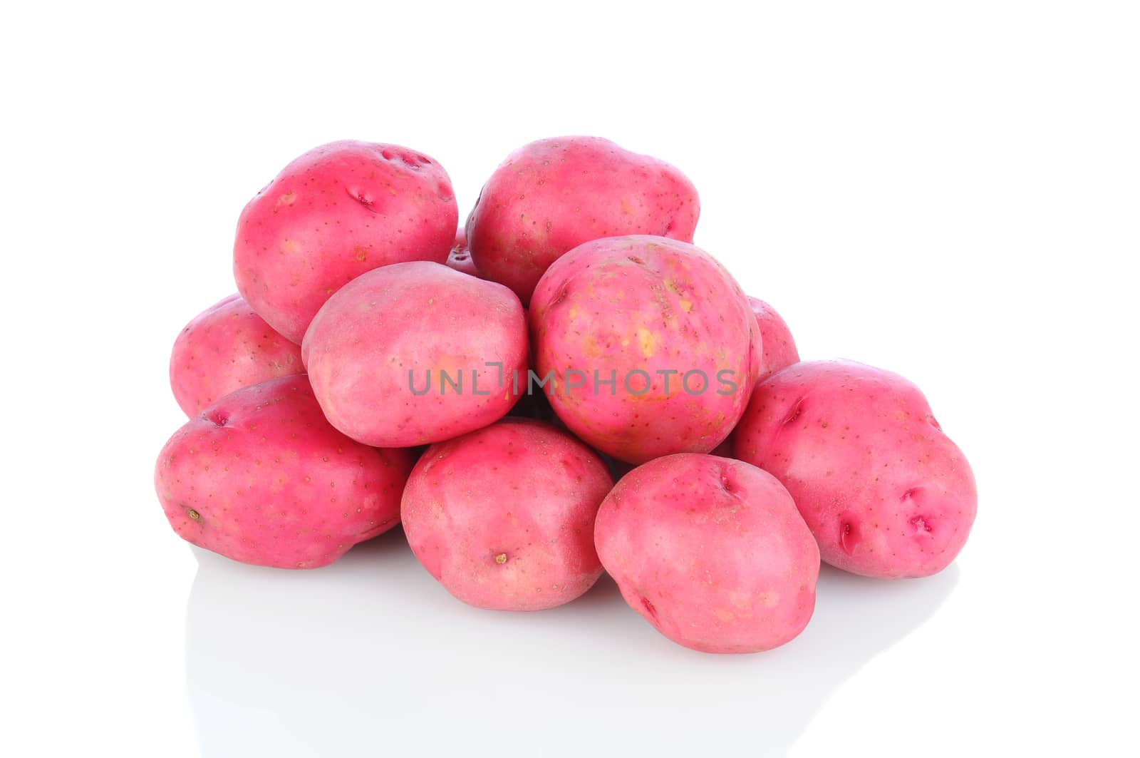 A pile of red potatoes on a white background with reflection, Horizontal format.