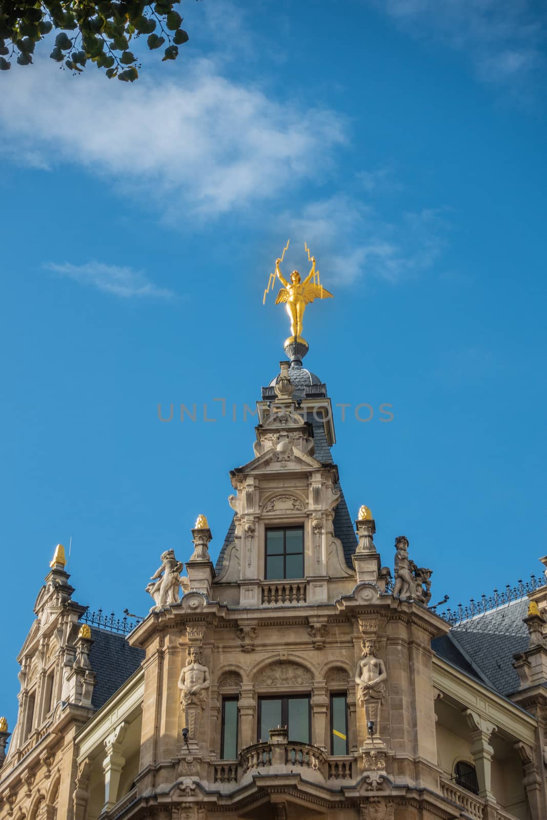 Golden Lightning carrying angel statue in Antwerp, Belgium. by Claudine