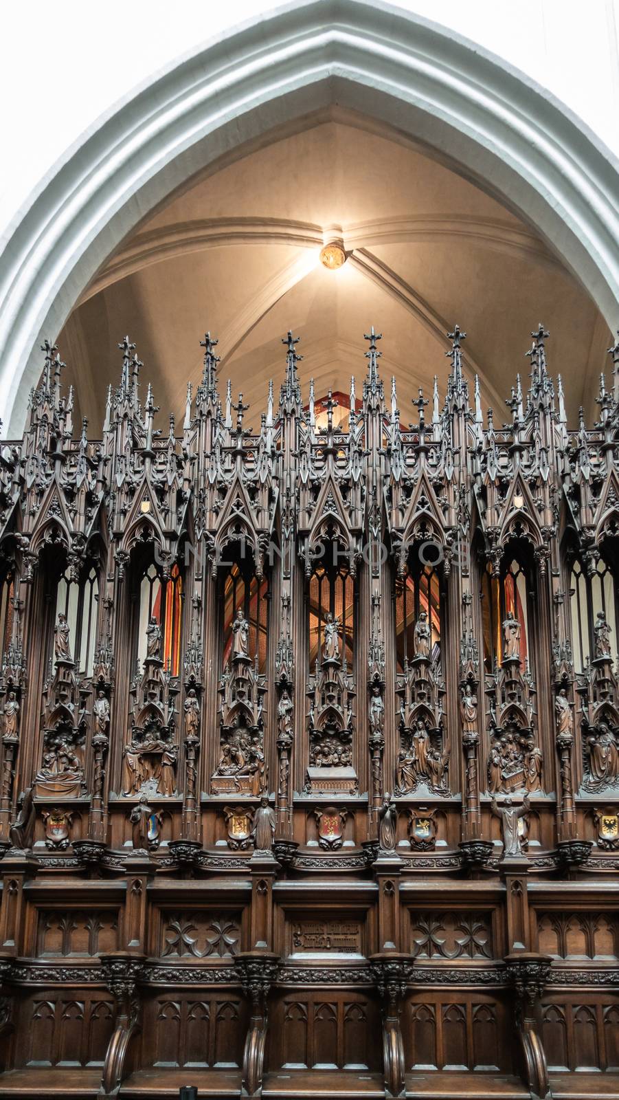 Antwerp, Belgium - September 24, 2018: Closeup of dark wooden sculpted Stables in Onze-Lieve-Vrouwe Cathedral of Our Lady. Members of congragation, leaders and dignitaries seats.