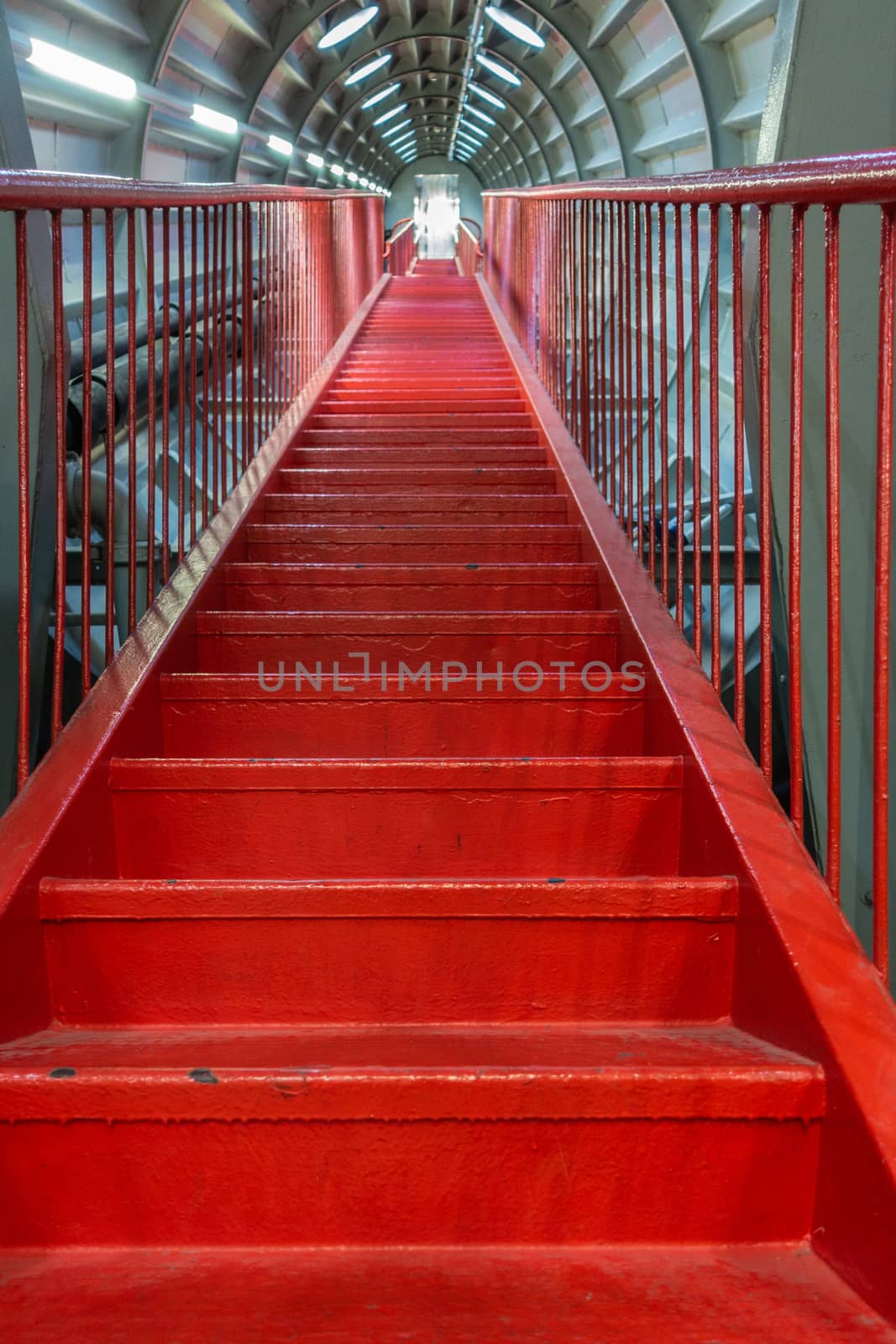 Brussels, Belgium - September 25, 2018: Red endless-like stairway to nowhere or heaven through one tube of Atomium Momument.