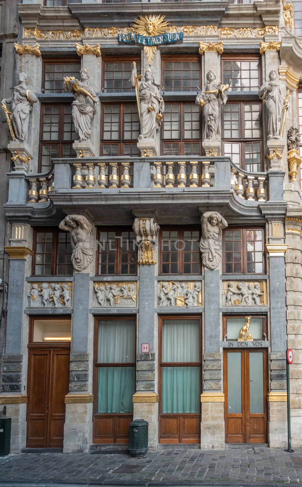 Brussels, Belgium - September 26, 2018: In Den Vos mansion on the Grand Place, Grote Markt, with goddess statues and golden decorations and Newton observation Pondere Et Mensura.