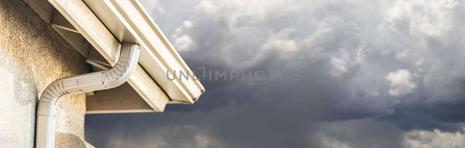 House with New Seamless Aluminum Rain Gutters With Storm Background Banner. by Feverpitched