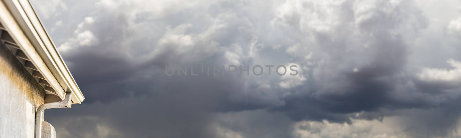 House with New Seamless Aluminum Rain Gutters With Storm Background Banner. by Feverpitched