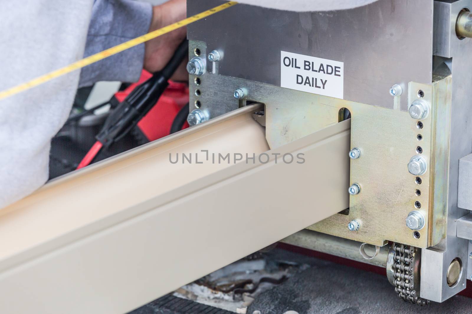 Worker Measuring Rain Gutter Processing Through Seamless Shaping Machine. by Feverpitched