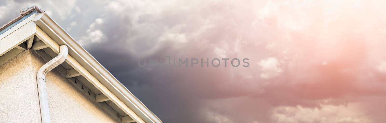 House with New Seamless Aluminum Rain Gutters With Storm Background Banner. by Feverpitched