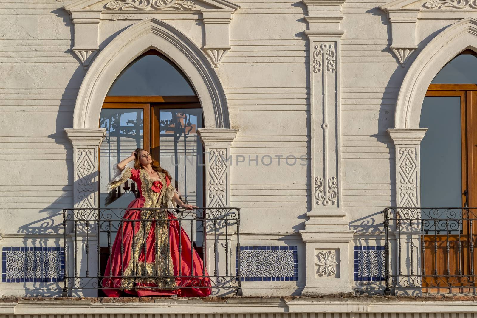A gorgeous Hispanic Brunette model poses in traditional Mexican clothing outdoors in home environment