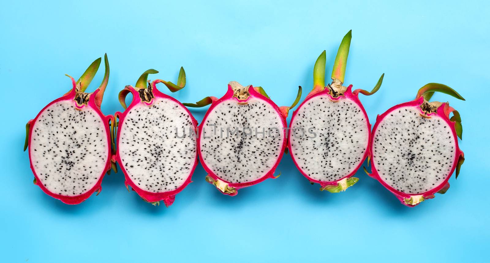 Ripe dragonfruit or pitahaya on blue background. Top view
